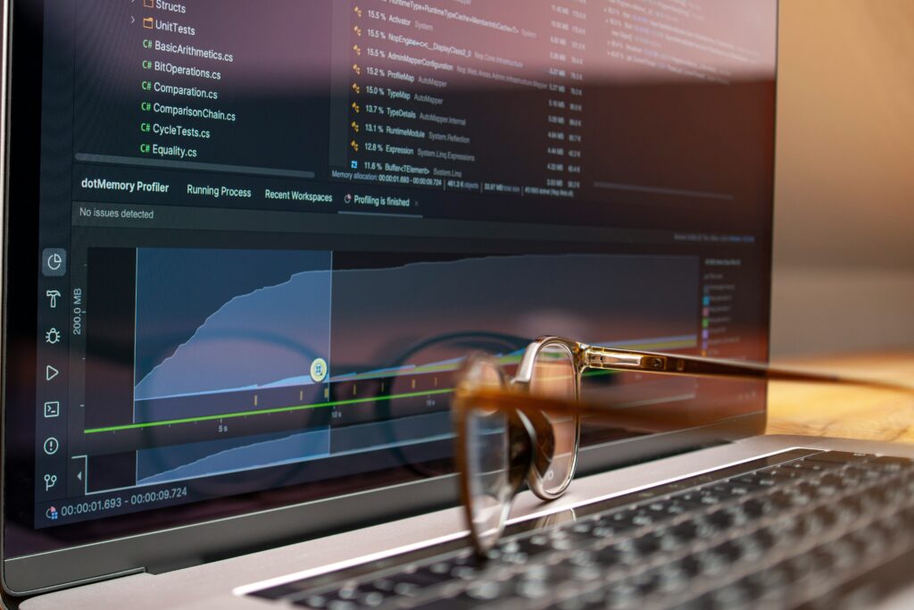 Laptop screen displaying data and performance graphs, representing analytical research support services